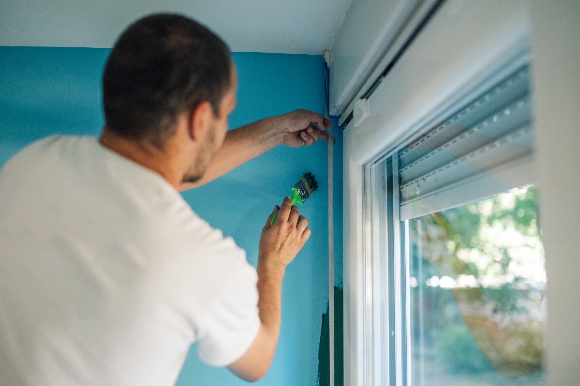 Professional painter applying fresh coat of paint